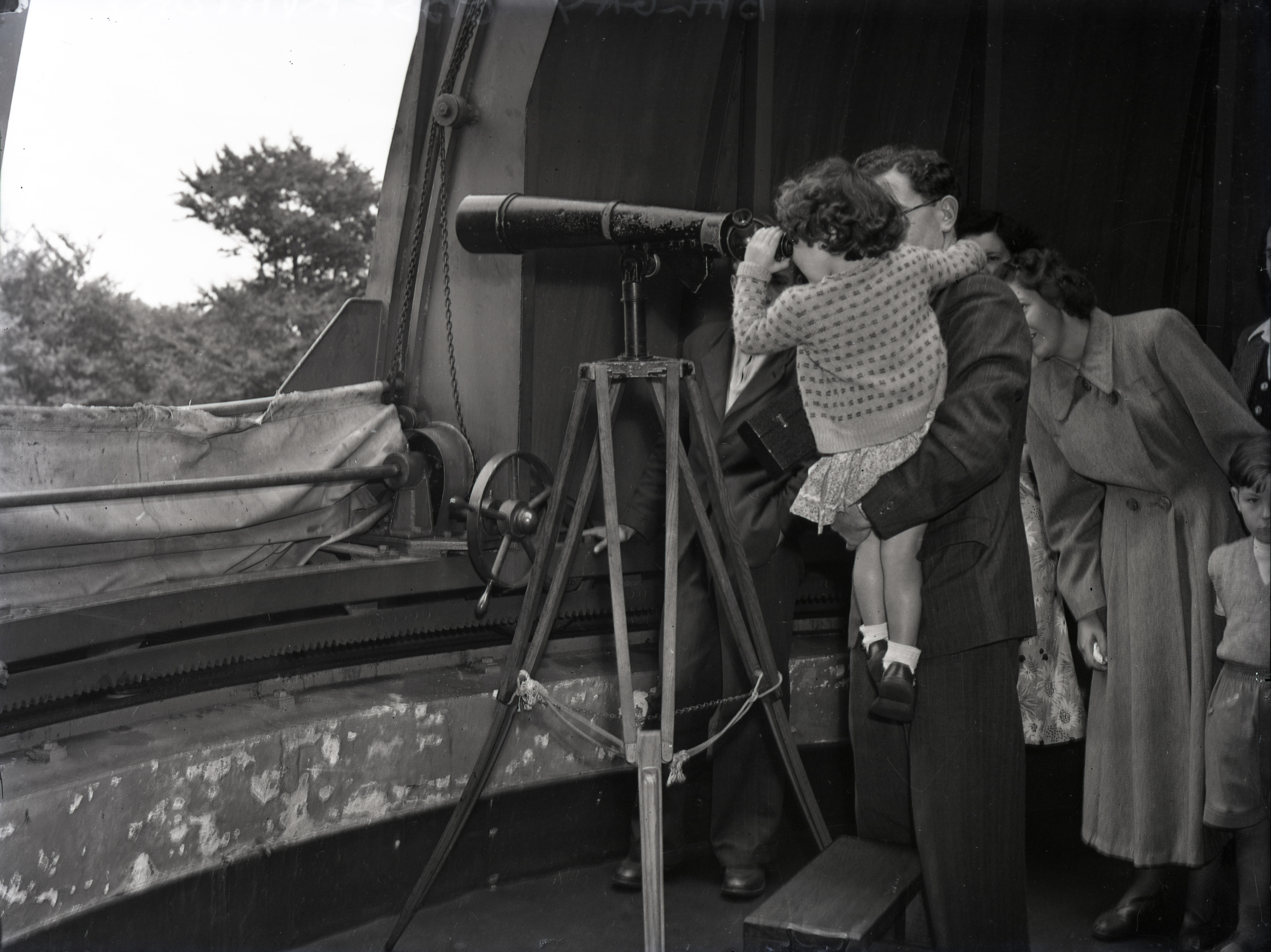 A family peers through one of the smaller telescopes at the observatory in 1934.