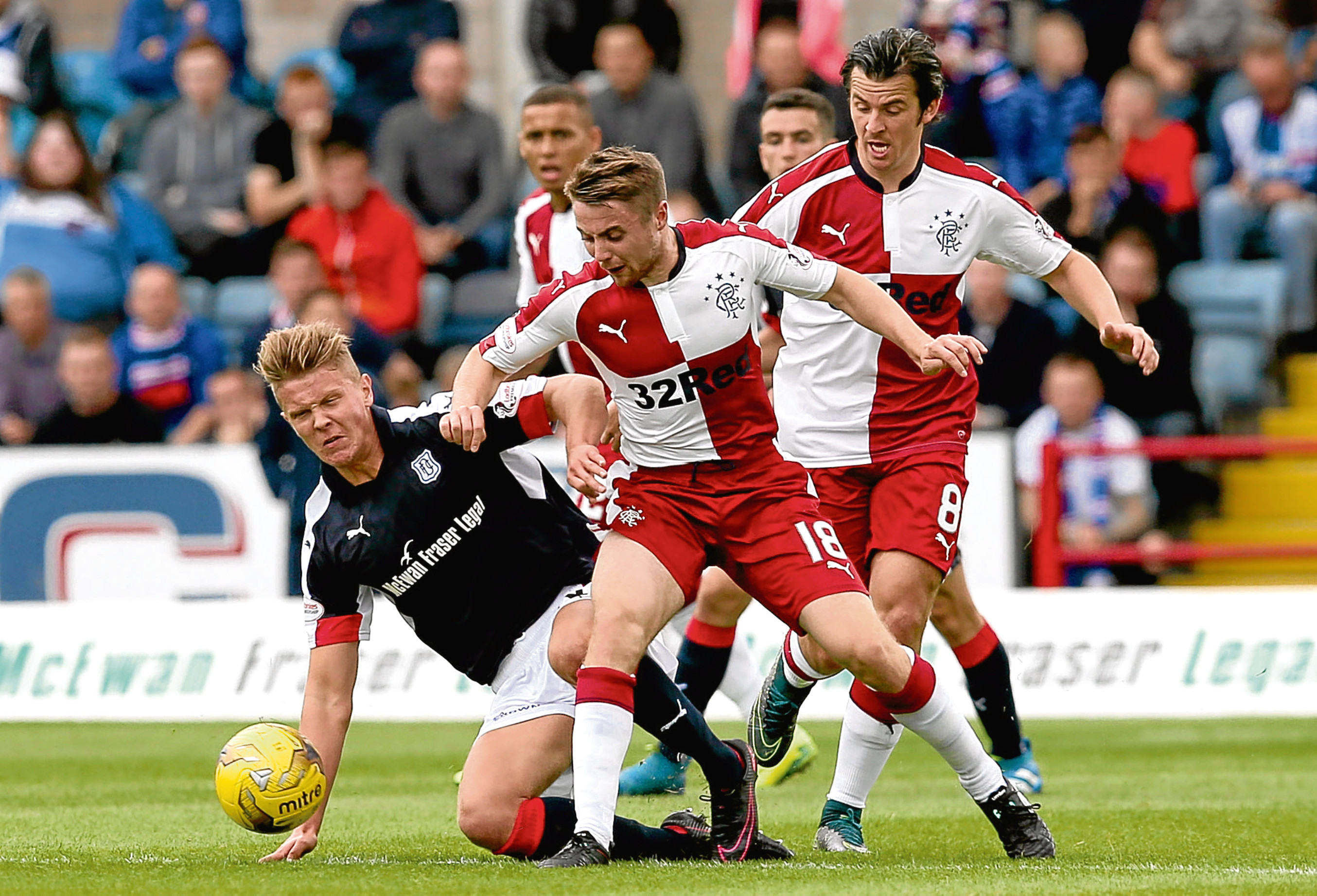 Mark O’Hara battles for the ball during the visit of Rangers in the Ladbrokes Premiership match at Dens Park on Saturday. Picture by David Young
