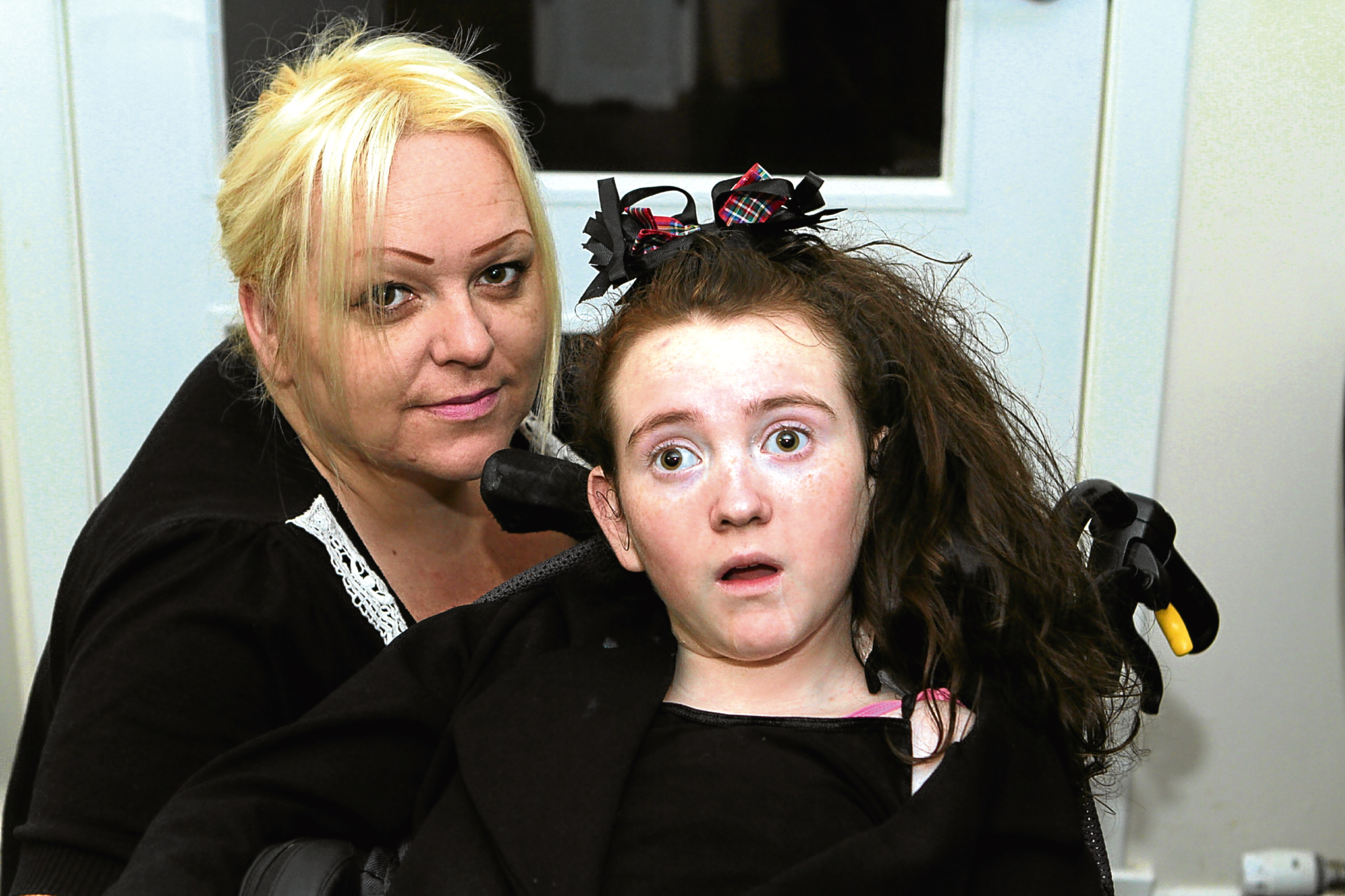 The teenager pictured at home with her mum, Michelle.