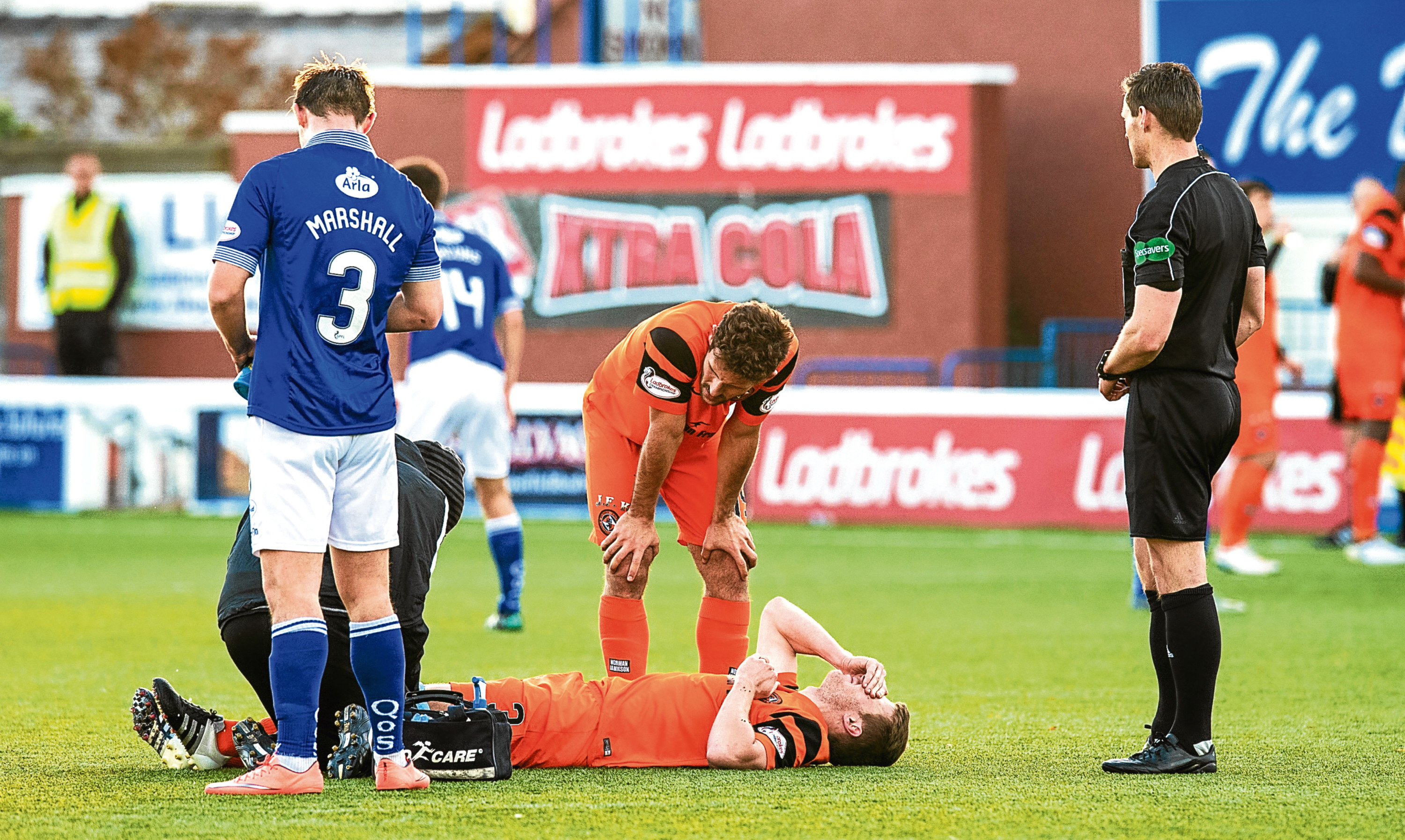 Paul Dixon getting treatment before being stretchered off.