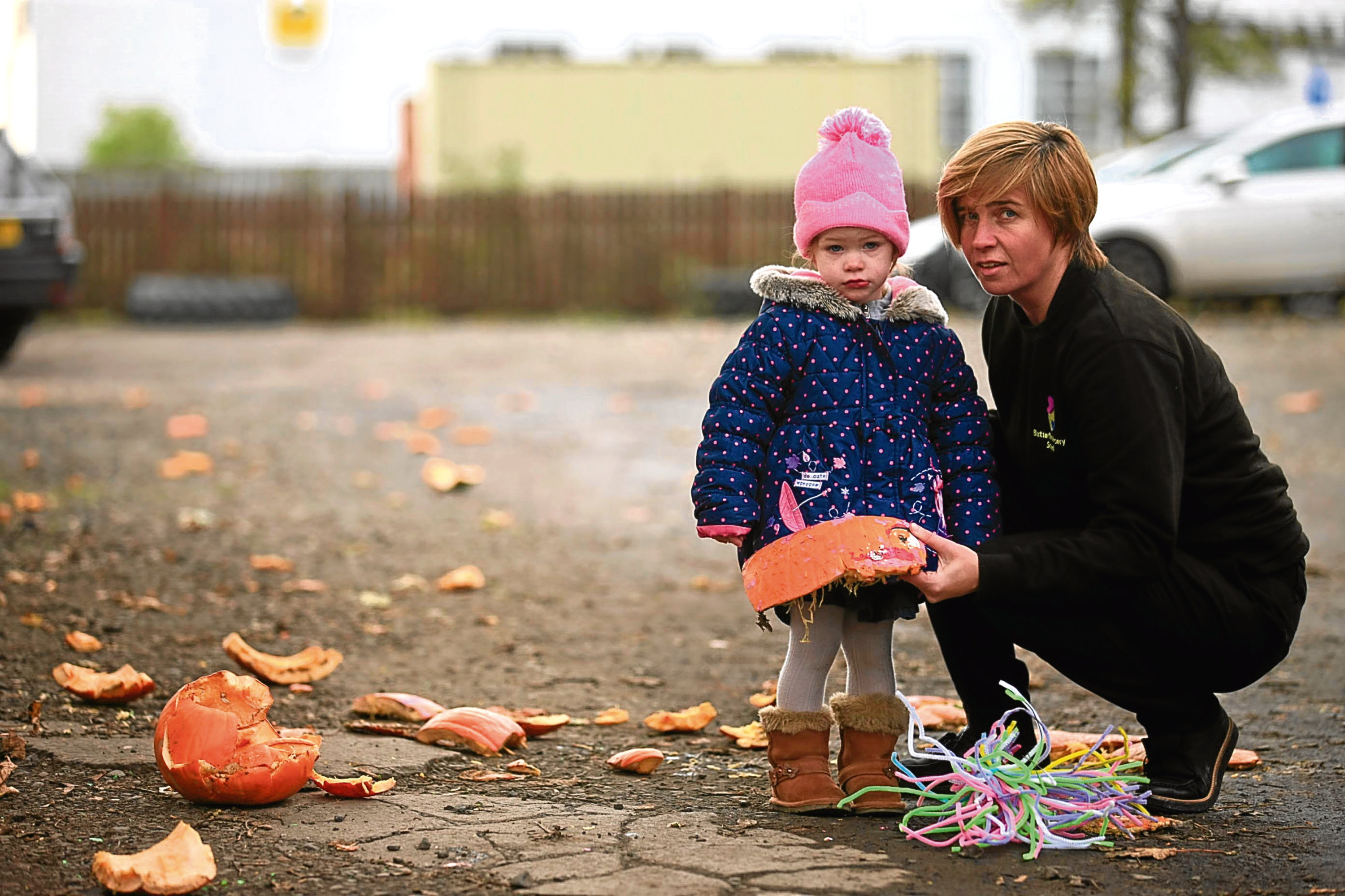 Two-year-old Teana McIntosh and Butterflies owner Teri Devine picking up the pieces at the nursery school.