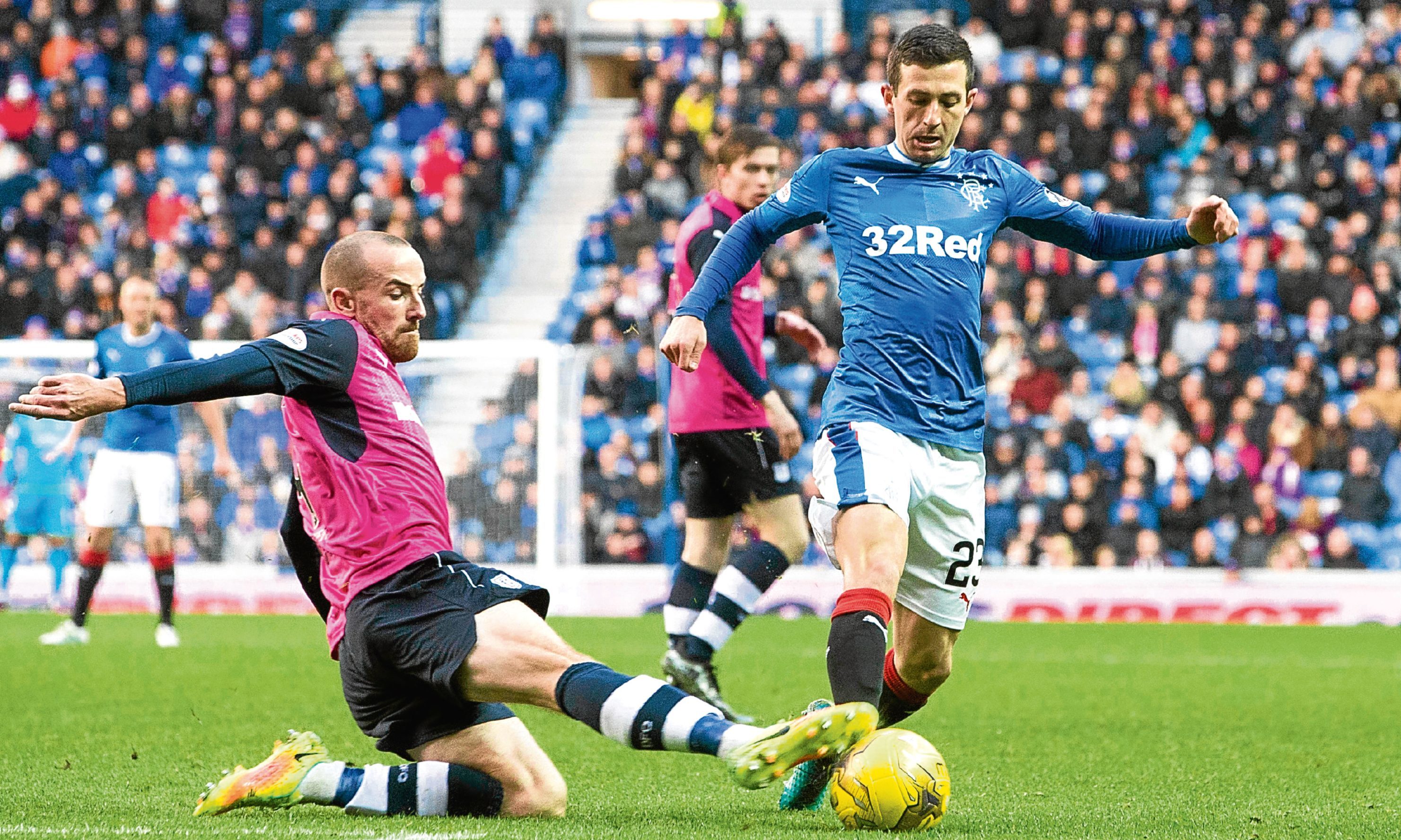 Dundee’s James Vincent displays the kind of fighting qualities Dundee will need when Inverness visit Dens as he puts in a timely tackle against Rangers’ Jason Holt last Saturday.