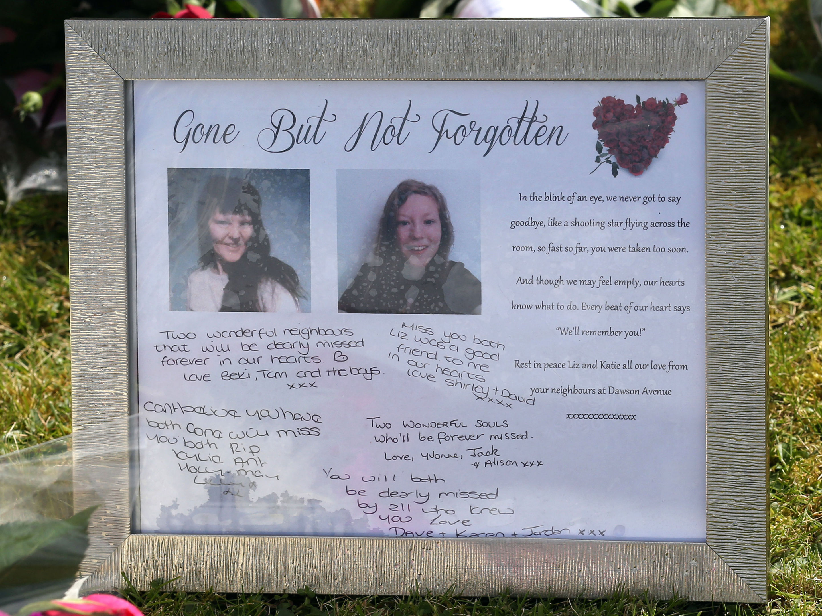 Tributes left outside the house where the bodies of 49-year-old Elizabeth Edwards and 13-year-old Katie were found