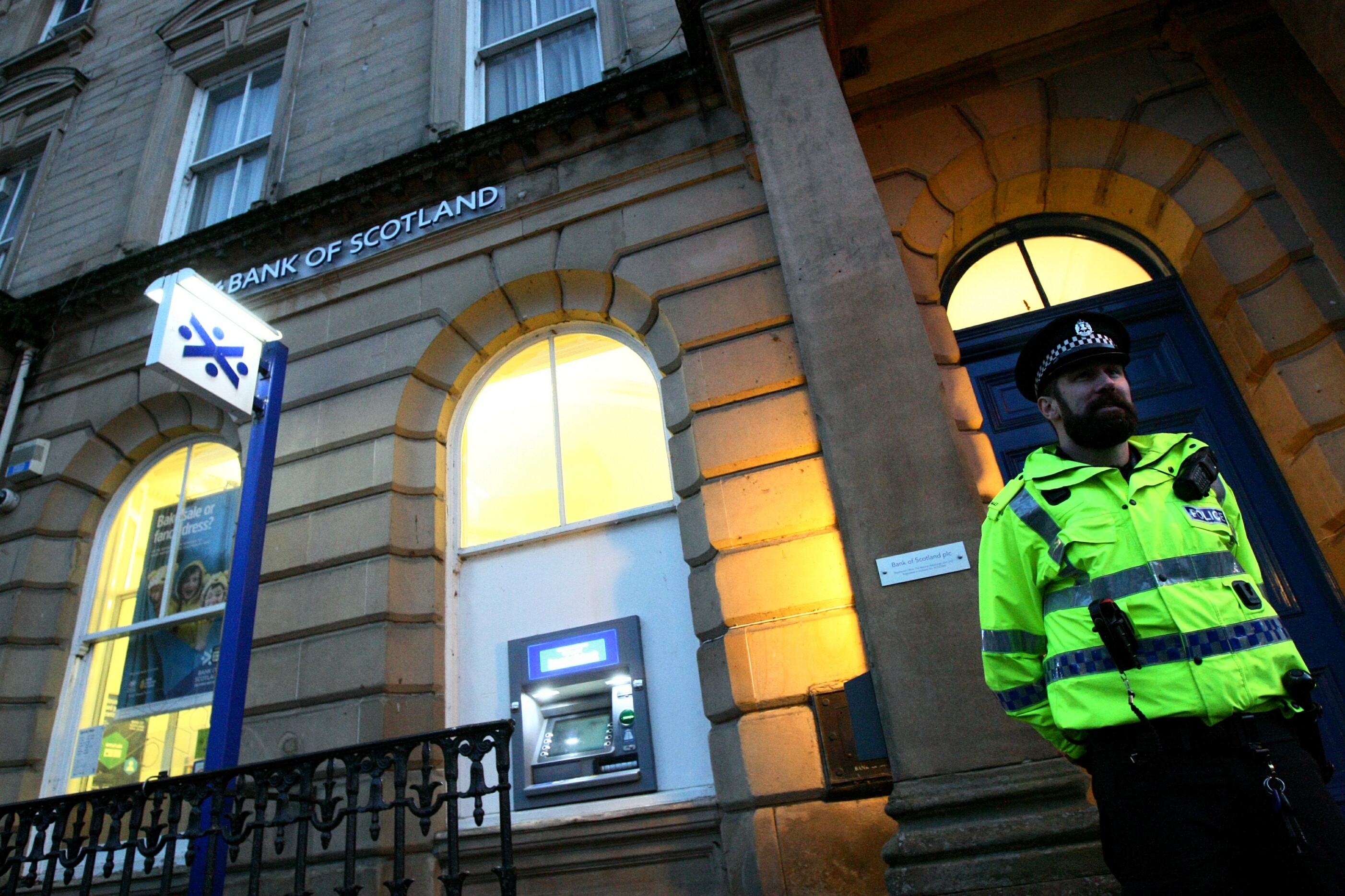 An officer stands guard outside the Bank of Scotland in Dunkeld
