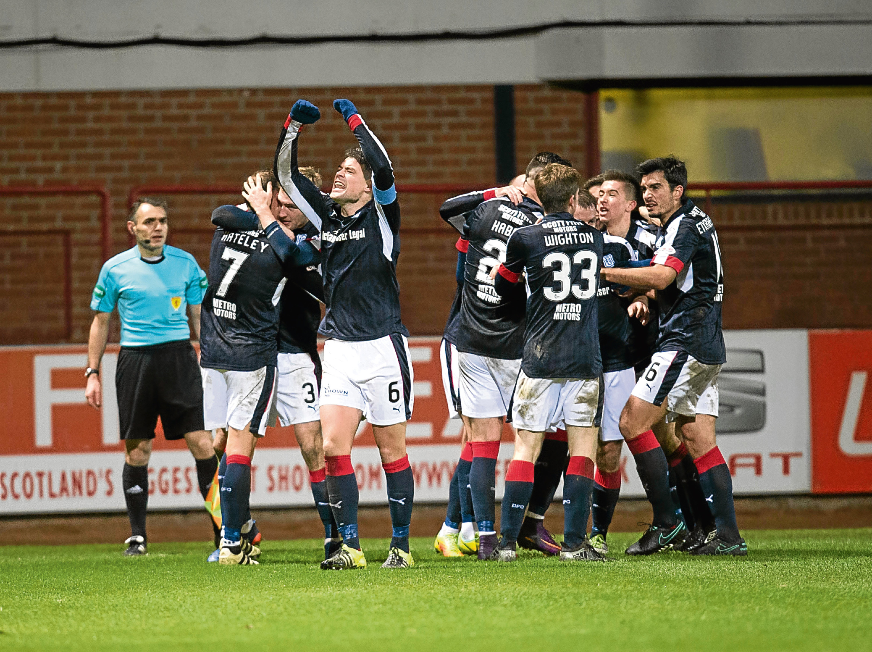 Dundee players celebrate the winning goal after a dramatic comeback against Heartd. Picture by David Young