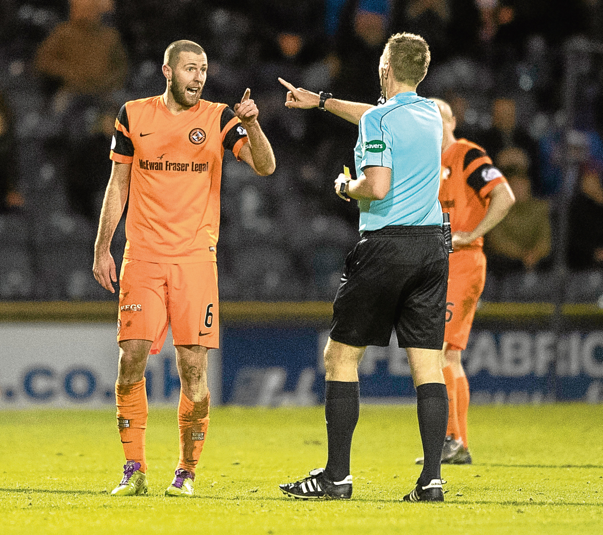 Dundee United's Lewis Toshney talks to referee Steven Kirkland during the goalless draw at Raith.