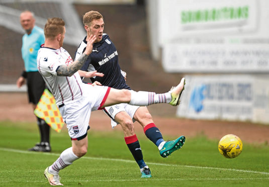 Dundees Kevin Holt is put under pressure from Michael Gardyne the last time Ross County visited Dens Park.