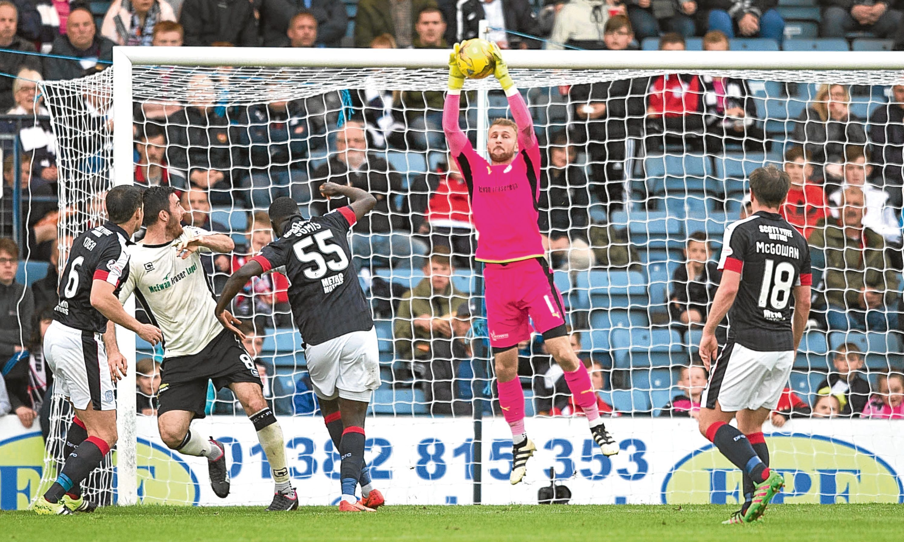 Scott Bain clutches this effort by Ross Draper at Dens on Wednesday night as Dundee allowed the Highlanders to return north with the points following a 2-0 defeat. Picture by David Young