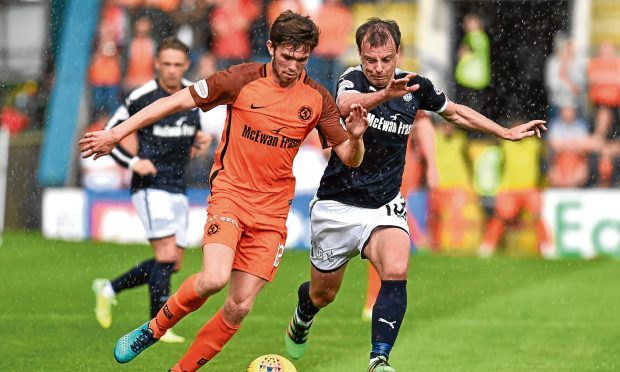 Sam Stanton — seen here tussling for the ball with Dundee’s Paul McGowan — enjoyed his first city derby when the Tangerines earned the penalty shootout extra point at Dens last Sunday.