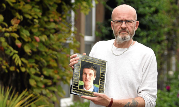 Phil Welsh with a photo of his son Lee.
