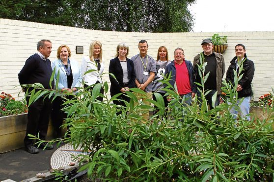 Shona Robison MSP (fourth from left) flanked by Dave Barrie and Lesley McLay, NHS Tayside chief executive, and other staff and volunteers at the opening of The Garden of Hope, at The Signpost Centre.