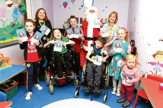 Youngsters on the ward meeting Santa.