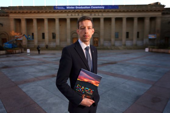 John Alexander, Leader of Dundee City Council, with the bid brochure