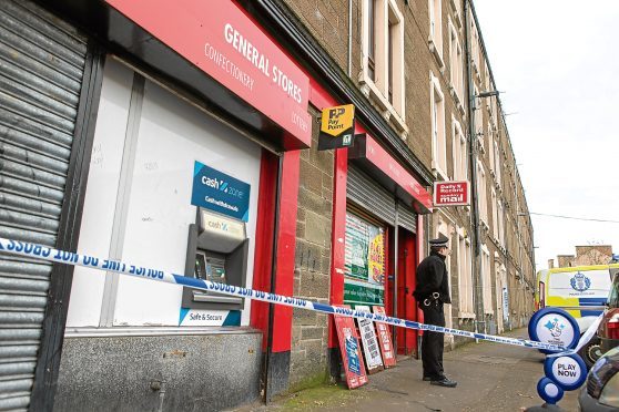 Police on the scene where a shop was allegedly robbed earlier this month