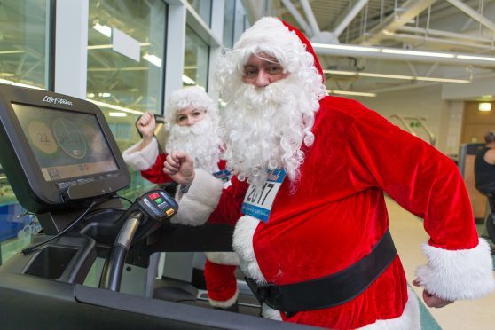Two Santas hit the treadmills in preparation for Sunday’s dash.