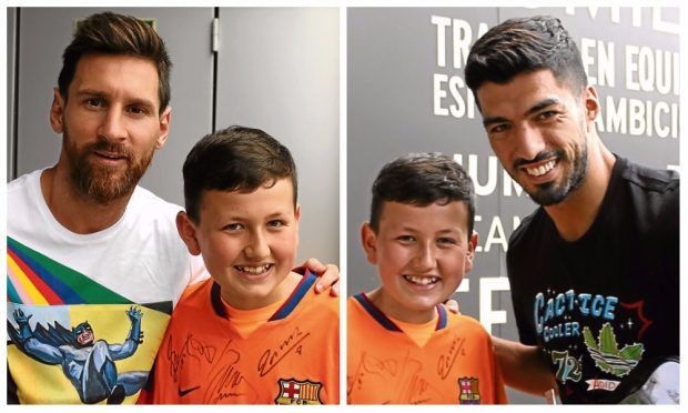 Sam pictured with Barcelona forward Lionel Messi and Luis Suarez