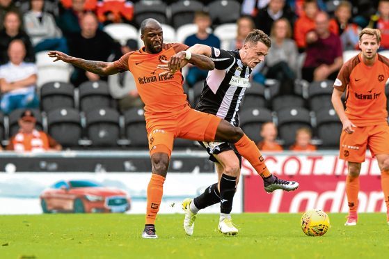 Dundee United's William Edjenguele (left) in action against Stephen McGinn