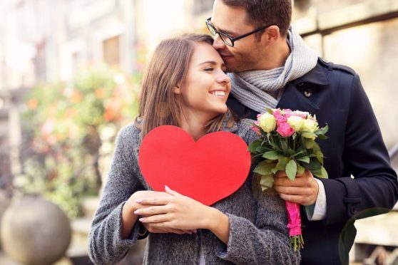 Picture of young couple with flowers and heart