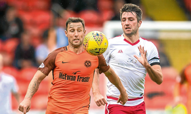 Dundee United's Scott MacDonald (left) takes on Brechin's Paul McLean
