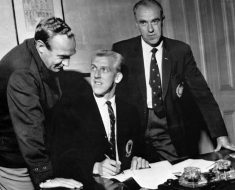 Bob Shankly (right) looks on as Ian Ure signs for Arsenal from Dundee