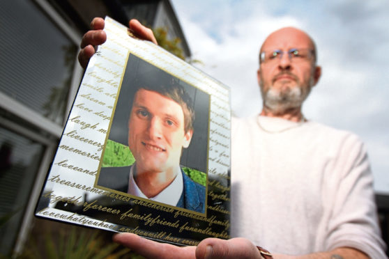 Phil Welsh with a photo of Lee, who took his own life