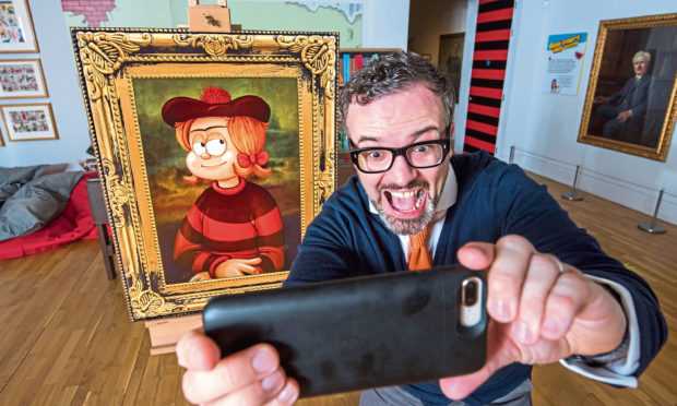 Mike Stirling with a portrait of Minnie the Minx at the McManus.