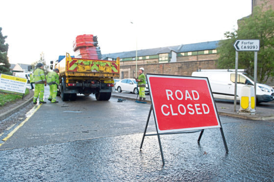 A sign warning drivers of disruption as resurfacing work takes place on Dura Street in Stobswell
