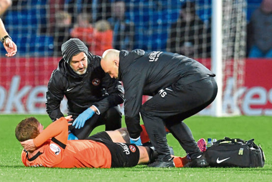 Fraser Fyvie receives treatment on the pitch during the weekend win at Ross County. The midfielder had to go off with a hamstring problem.