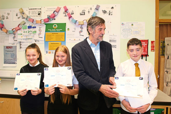 Brian Carroll of the British Science Association awards prizes to Demi Perrie (far left), Joel Campbell and Cerys Rutter