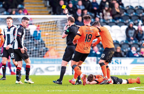 Referee Willie Collum shows a yellow card to Paul McGinn after the St Mirren man had clashed with Dundee United attacker Cammy Smith