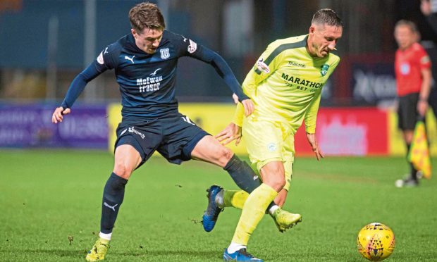 Scott Wright (left) competes with Hibernian's Mark Milligan, during his time with Dundee.