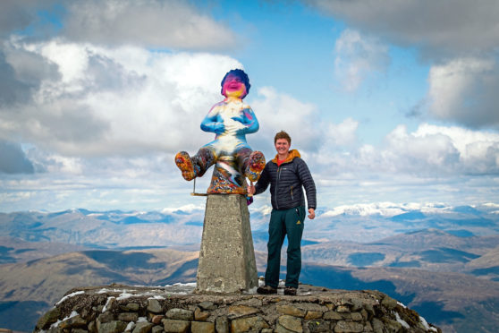 Douglas Roulston with a statue of Oor Wullie to the top of Ben Nevis