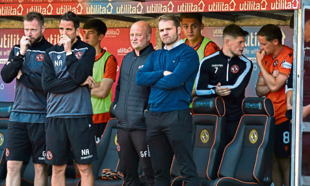 The United bench look on during the match against Arbroath on Sunday in the Challenge Cup.