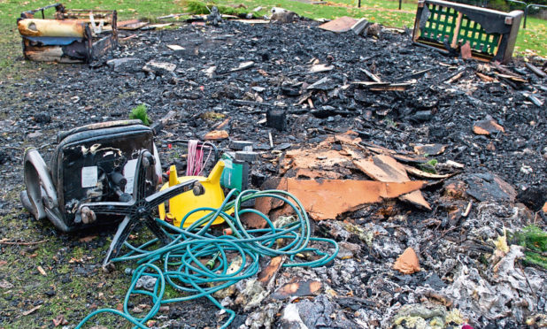 The charred mess and debris left after the bonfire in Kirkton, which firefighters were forced to put out.