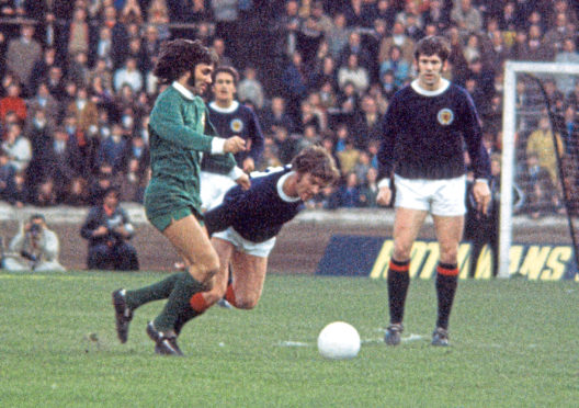Northern Ireland's George Best wins the ball from Hugh Curran in the 1971 Home Championships.