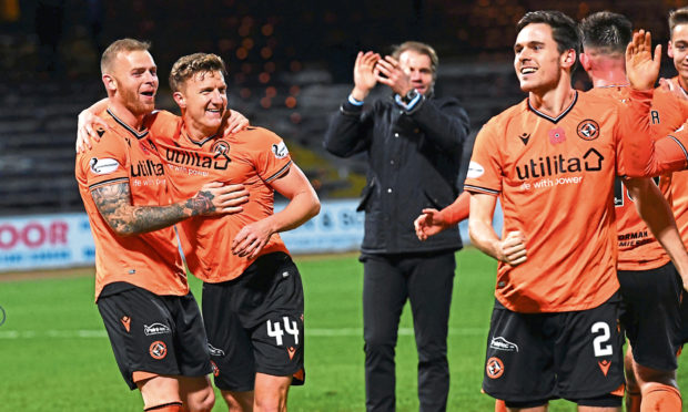 The Dundee United players celebrate at full-time at Dens on Friday.