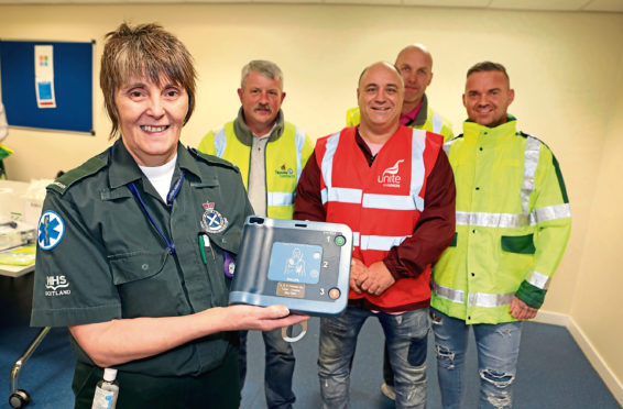 Hazel with Colin (in the red vest), and Paul Drummond, George Millar and Jim Cosgrove, from Tayside Contracts Dundee at the handover.