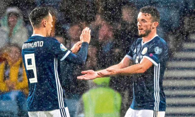 Lawrence Shankland’s (left) fellow-Scotland international John McGinn (right) was subject of interest from the Dundee United hitman’s suitors Nottingham Forest in 2018.