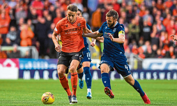 Dundee United's Louis Appere battles with Dundee's Jamie Ness.