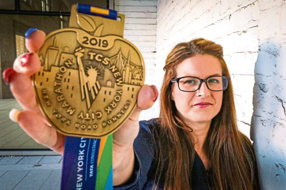 Lisa with her New York Marathon medal.