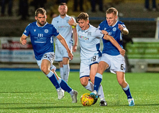 Queen of the South's Michael Paton and Daniel Pybus in action with Dundee's Finlay Robertson.