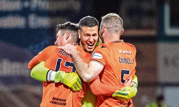 Dundee United's Benjamin Siegrist (centre) celebrates with Jamie Robson.