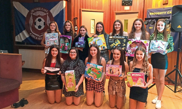 Members of the team with some of the gifts they are donating.