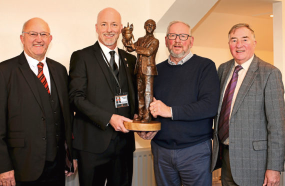 Dundee United Community Trust chairman David Dorward, club owner Mark Ogren, sculptor Alan Heriott and Jim McLean Statue Group chairman George Haggarty with a bronze model of how the finished statue will look.