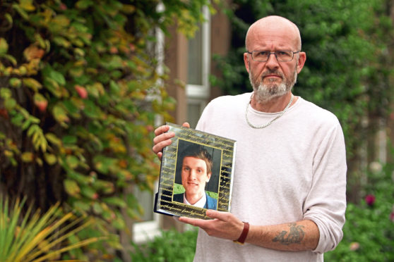 Phil Welsh with a photo of Lee.