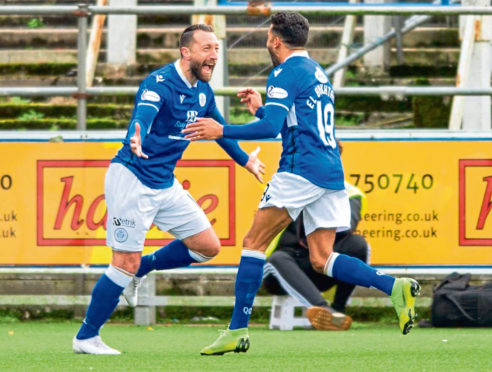 Queen of the South's Stephen Dobbie (left) celebrates his opening goal during the match between Queen of the South and Dundee United.