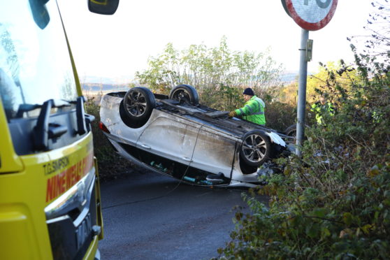 The overturned car on the road.