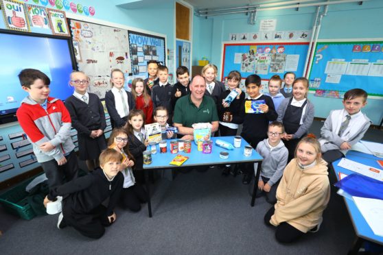 Kenneth Linton, of Dundee Foodbank, pictured with P5 pupils at Ardler Primary School.