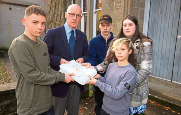 John Swinney recieved a petition from pupils Sol Archibald, Duncan Fairlie, Tori Rennie and Ben Gilyeat when the school closed.