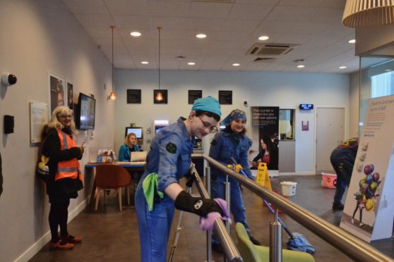 Extinction Rebellion protesters "cleaning up" the Barclays branch in Dundee.
